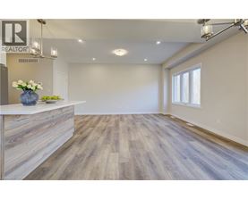 A realtor's office with a reception desk and a large open space.