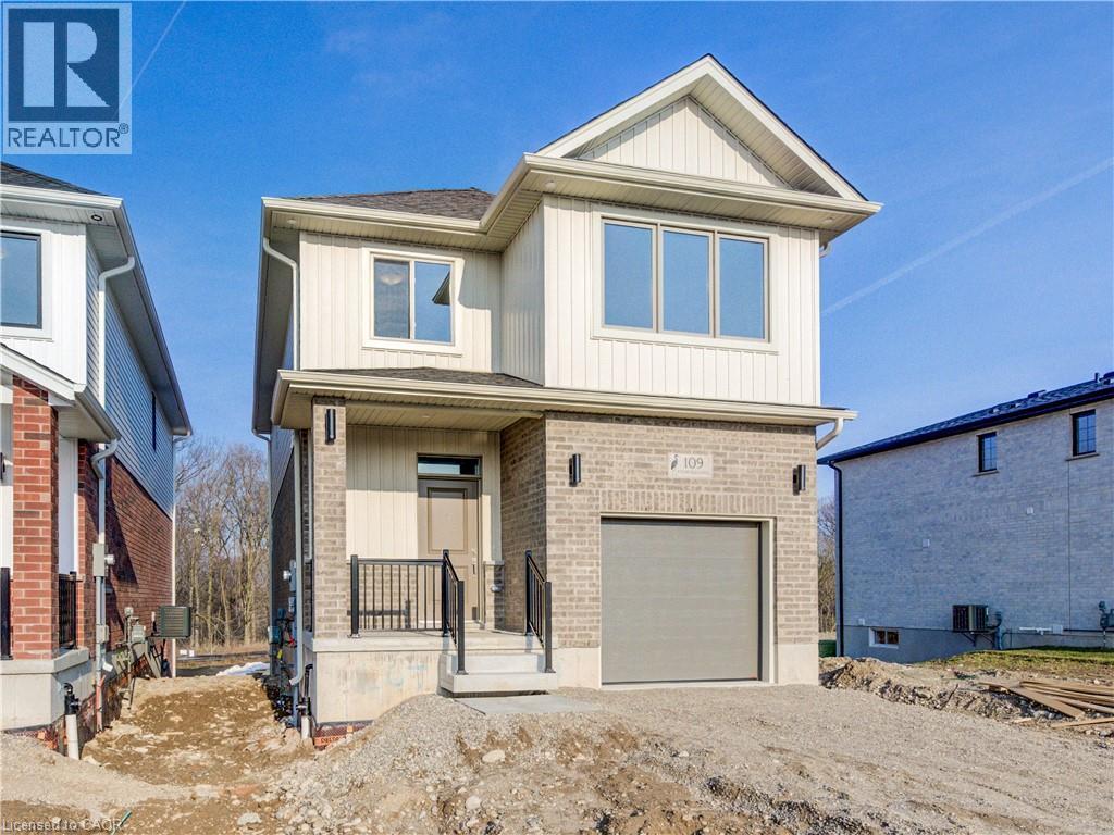 A two-story house with a garage is under construction.