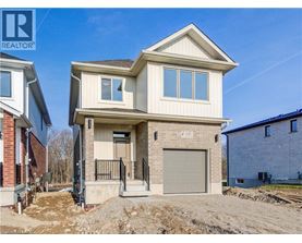 A two-story house with a garage is under construction.