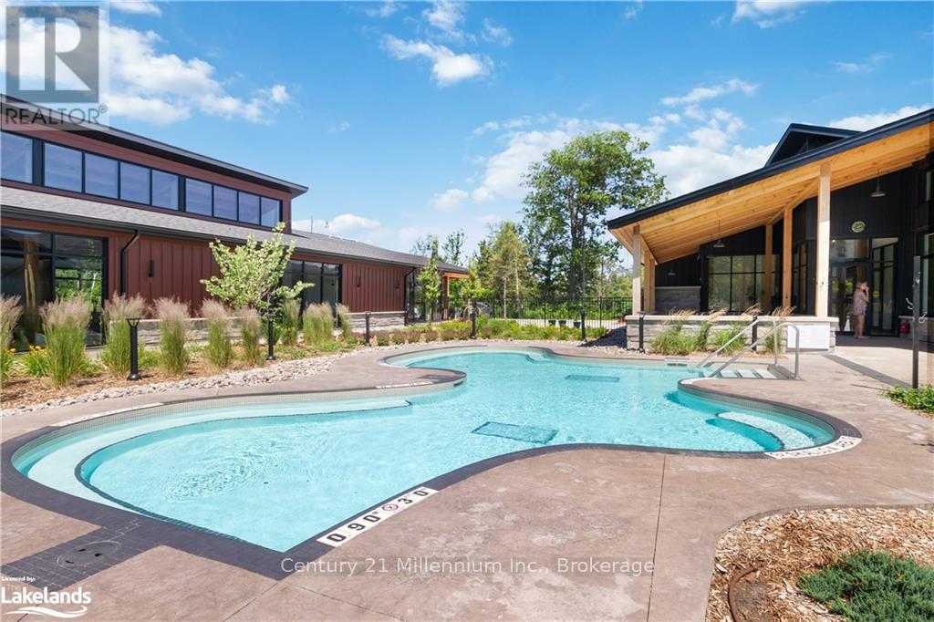A swimming pool in a backyard with a building in the background.