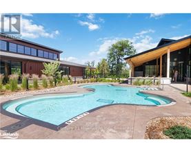 A swimming pool in a backyard with a building in the background.