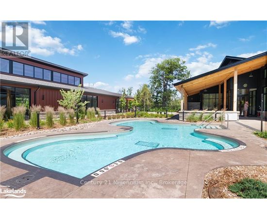 A swimming pool in a backyard with a building in the background.