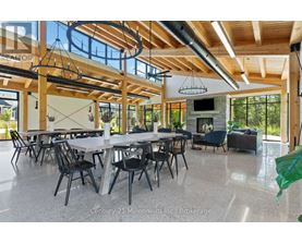 A spacious dining area with a long table and chairs.