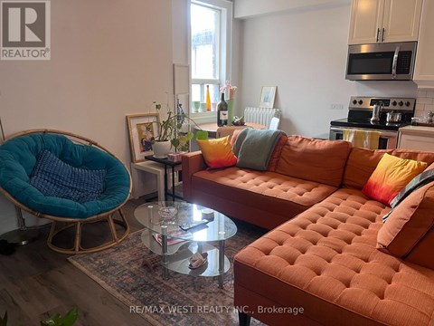 A living room with a brown tufted couch and a blue chair.