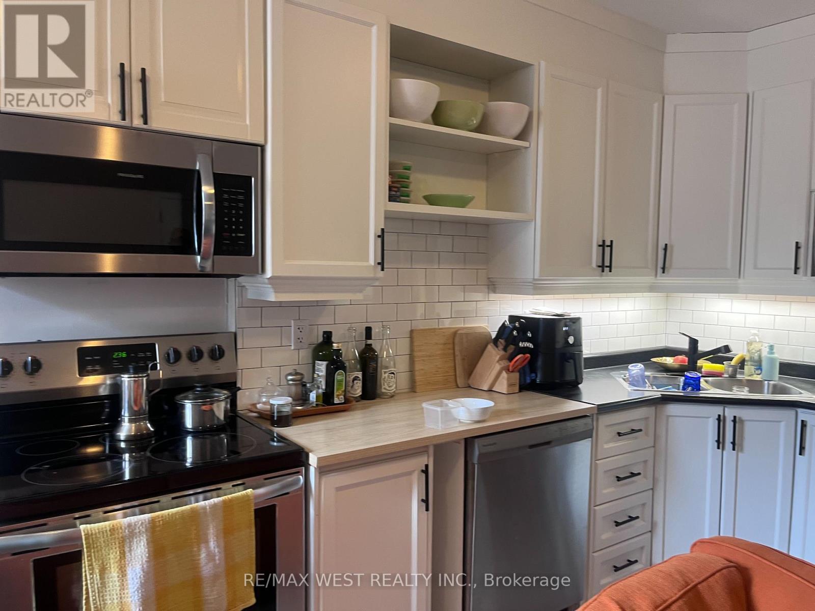 A kitchen with a stove top oven and microwave.
