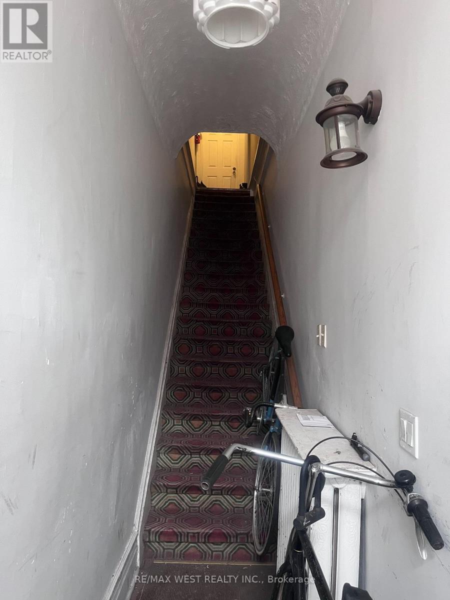 A hallway with a bicycle leaning against the wall.