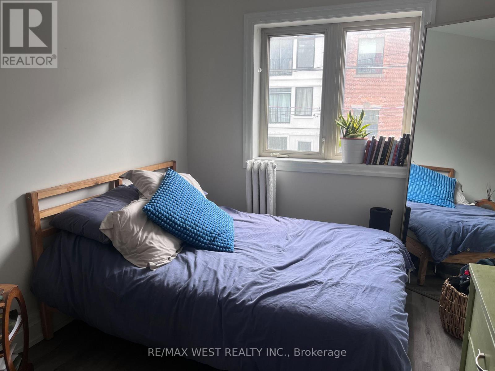 A bedroom with two beds and a window.