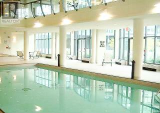 A large indoor swimming pool with a glass bottom.