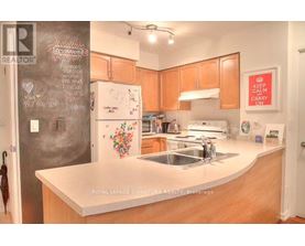A kitchen with a chalkboard wall and a white fridge.