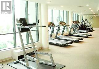 A gym with treadmills and a treadmill with a ladder attached to it.