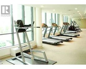 A gym with treadmills and a treadmill with a ladder attached to it.