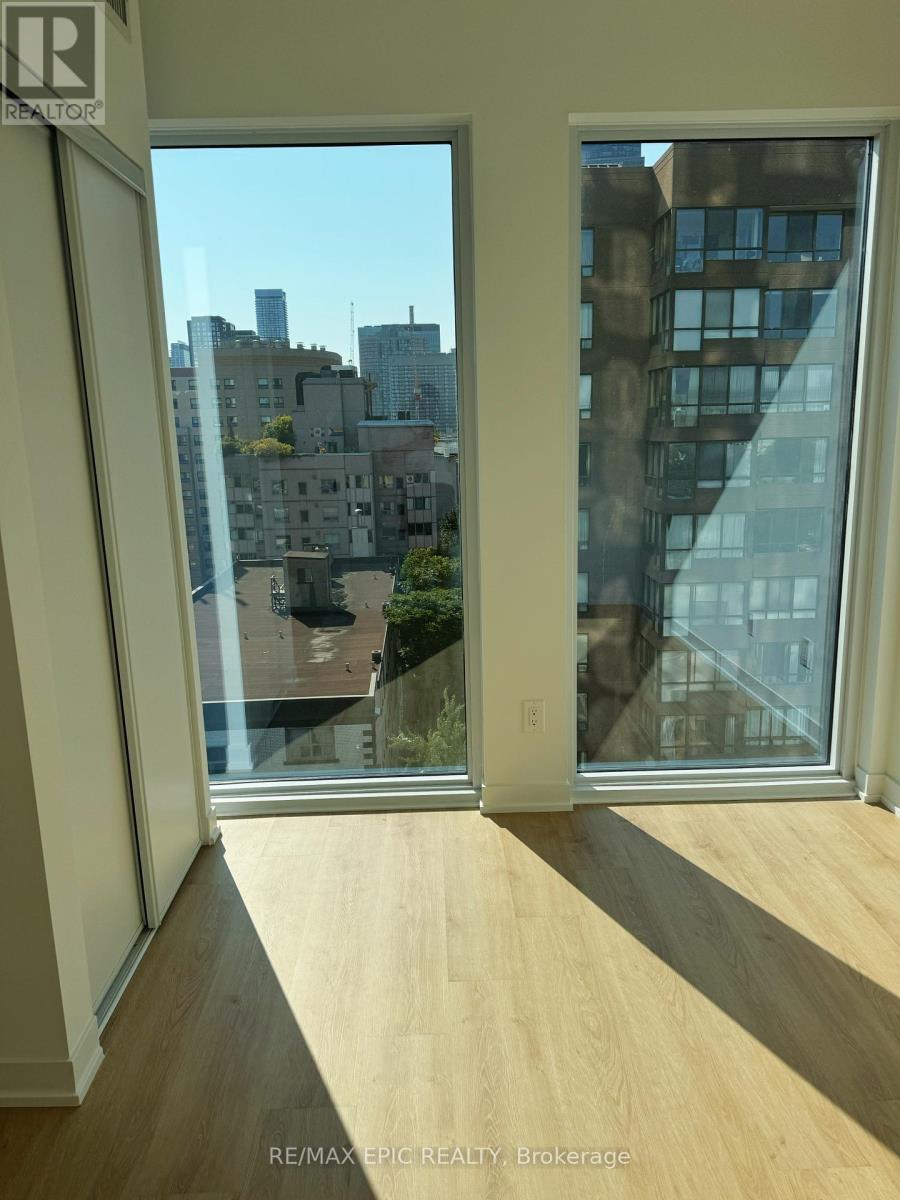A room with a view of the city through large windows.
