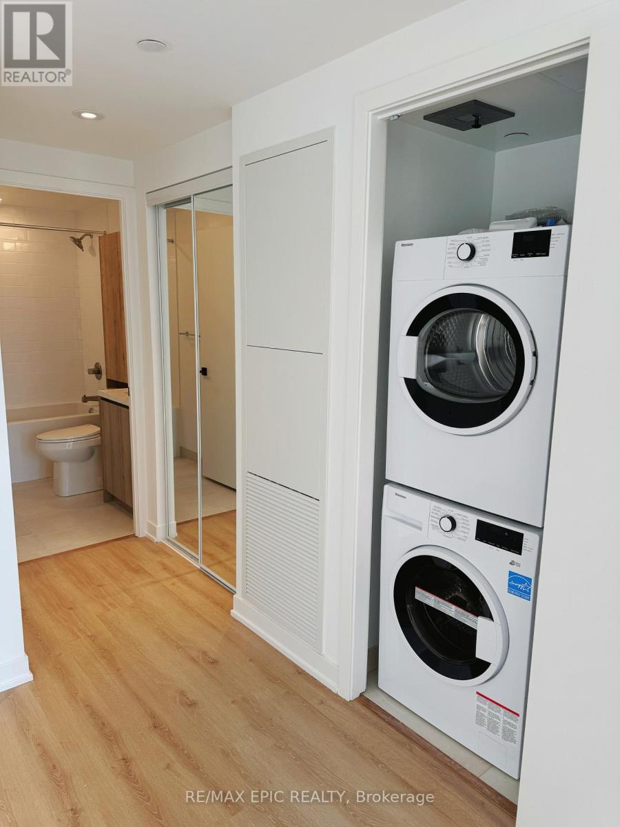 A white washer and dryer in a small room.