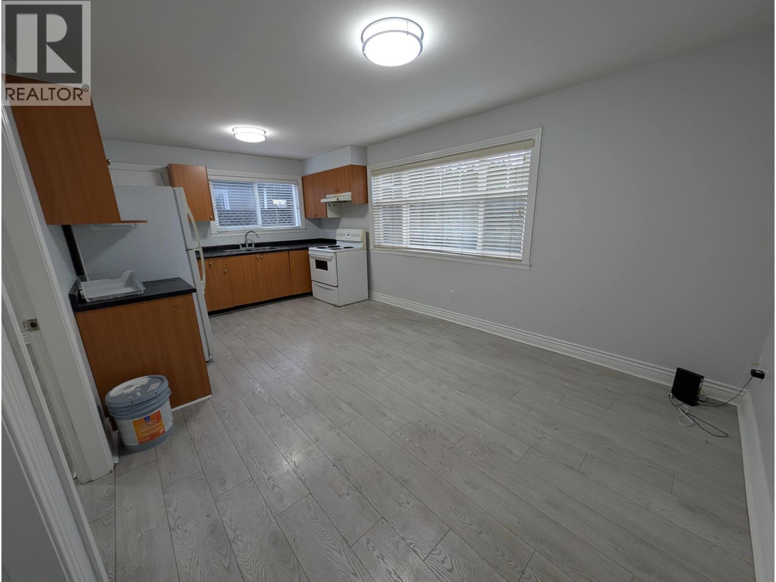 A kitchen with a white fridge and a white dishwasher.