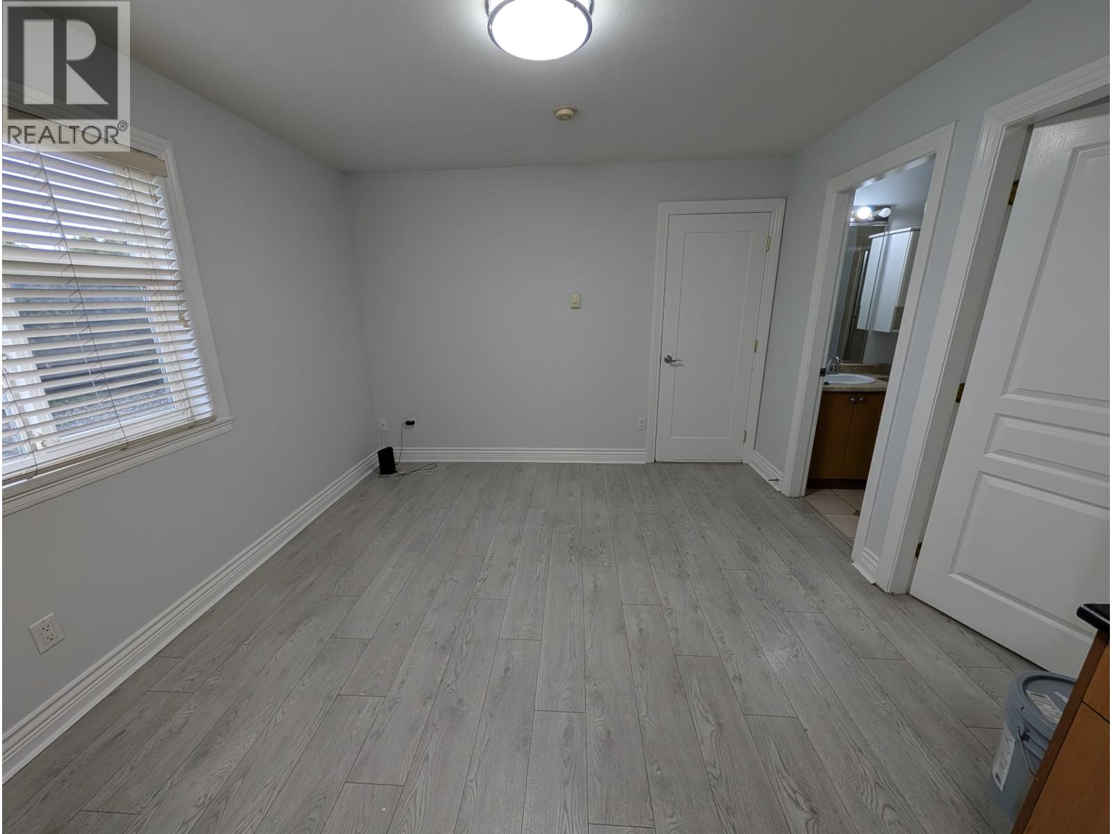 A room with a wooden floor and white walls.
