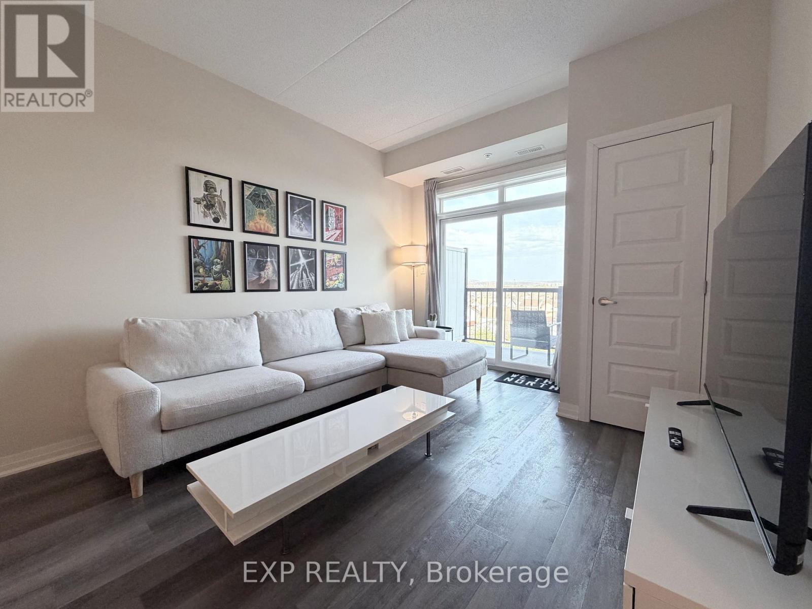 A living room with a white couch and a television.