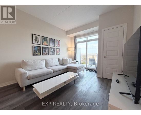 A living room with a white couch and a television.