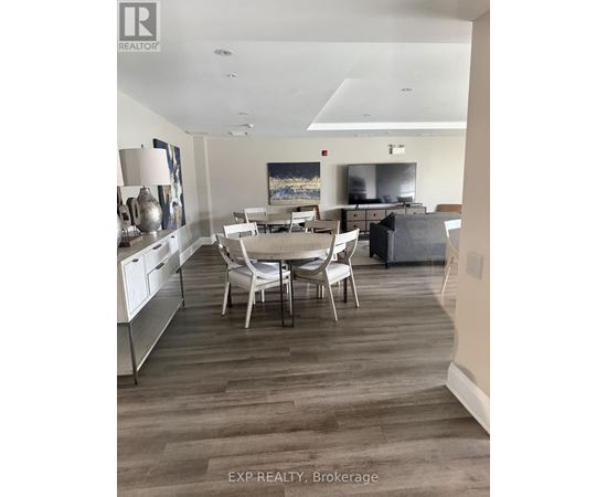 A dining room with a table and chairs.
