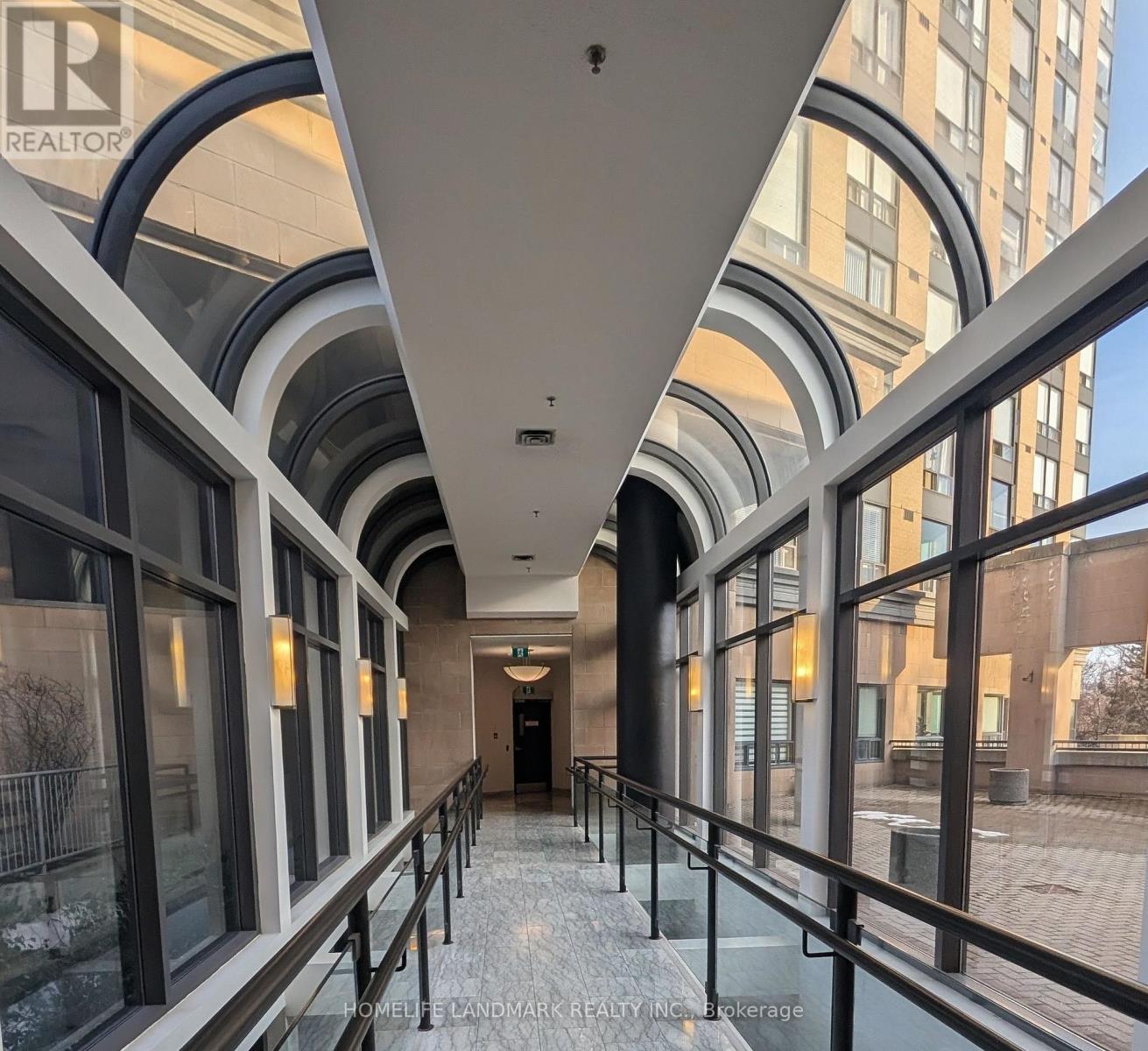 A long hallway with a balcony on the right side.