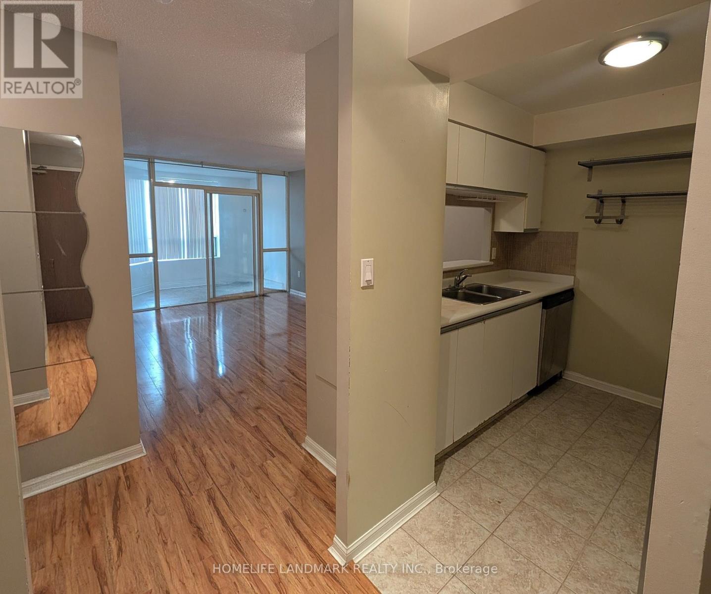 A kitchen area with a sink and a countertop.