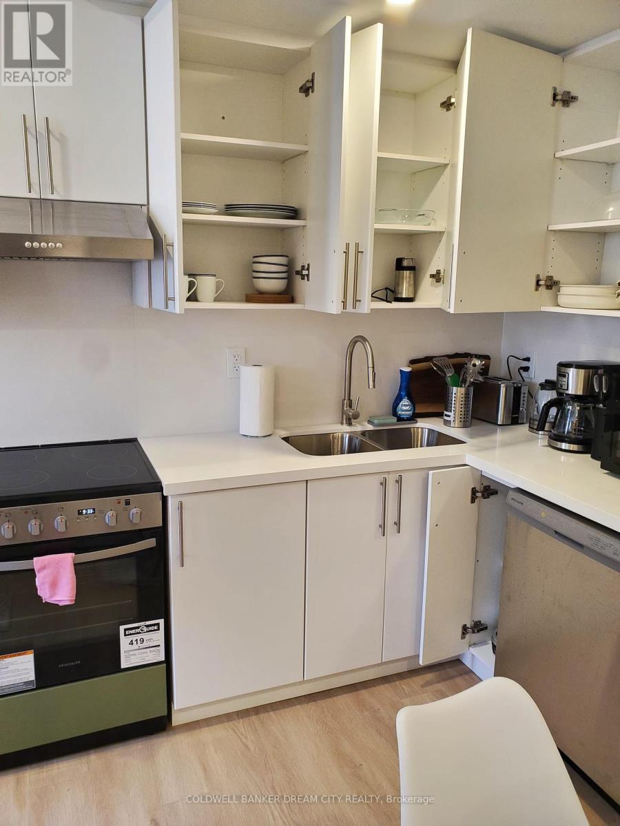 A kitchen with white cabinets and a black oven.