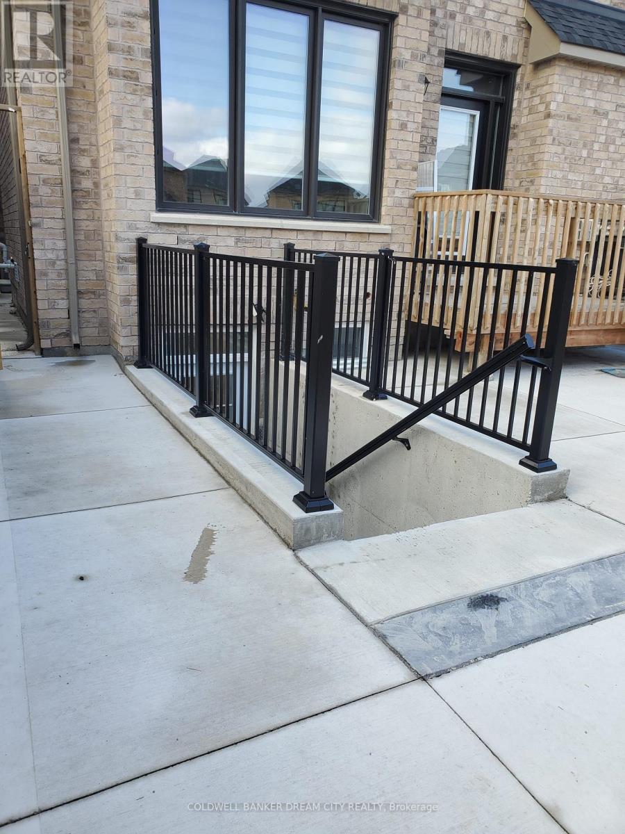 A black metal railing on a concrete walkway.