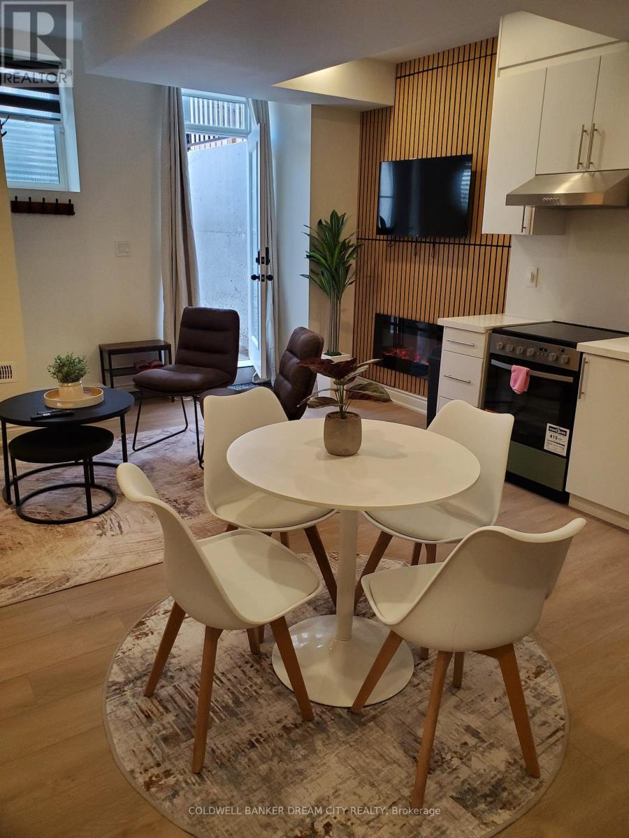 A modern dining room with a white table and chairs.