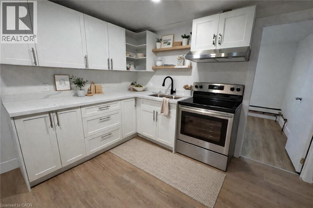 A kitchen with white cabinets and a stainless steel oven.