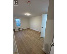 A room with wooden flooring and a window.