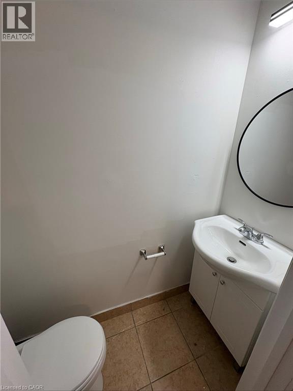 A white toilet sits next to a sink in a small bathroom.