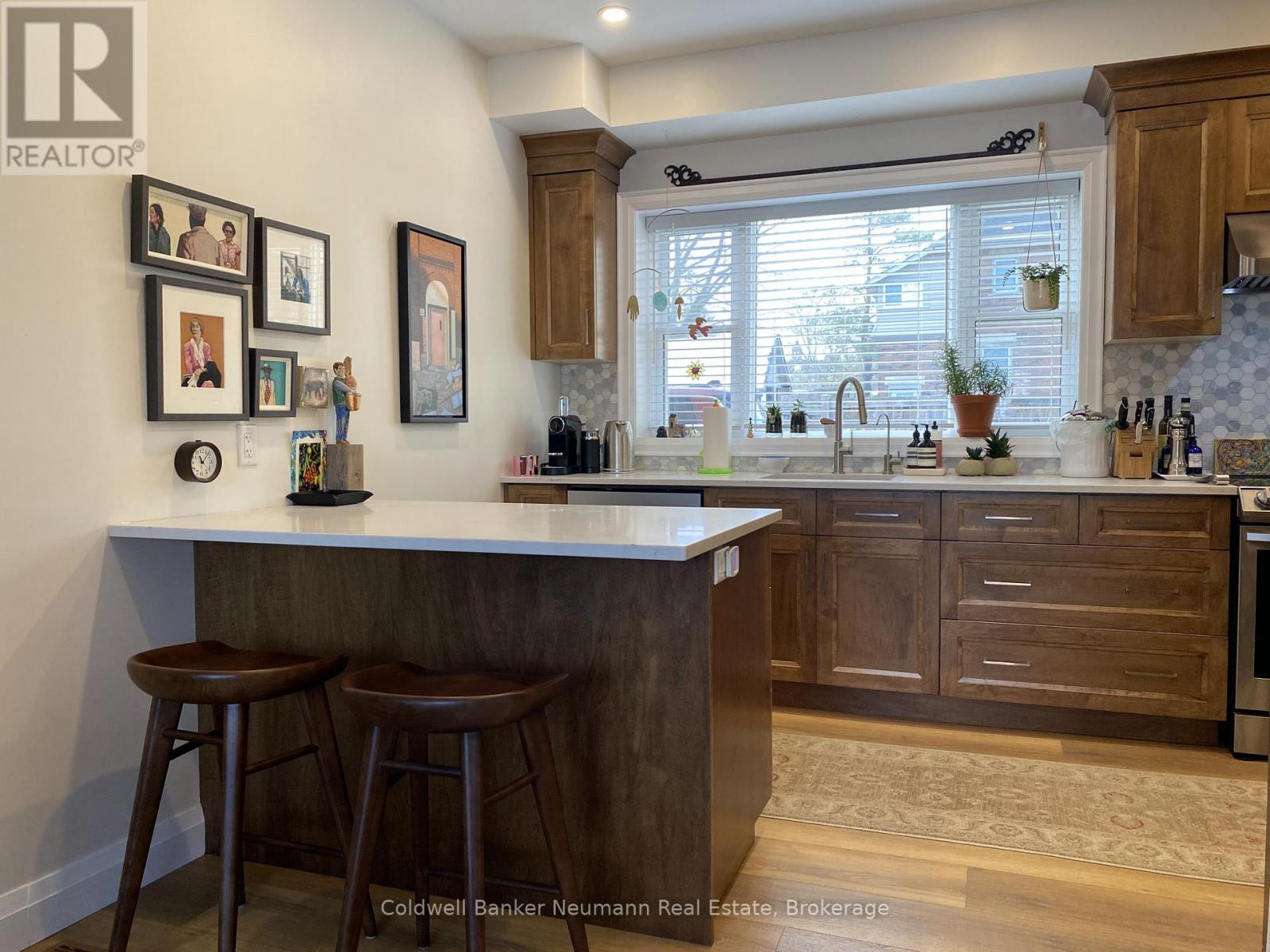 A kitchen with a bar area and a window.