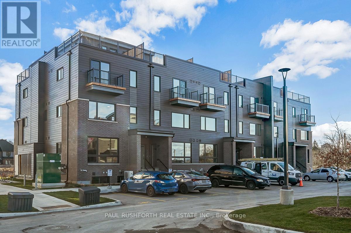 A modern apartment building with cars parked in front.