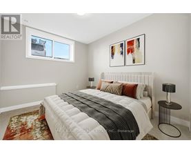 A bedroom with a large bed and a window.