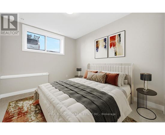 A bedroom with a large bed and a window.