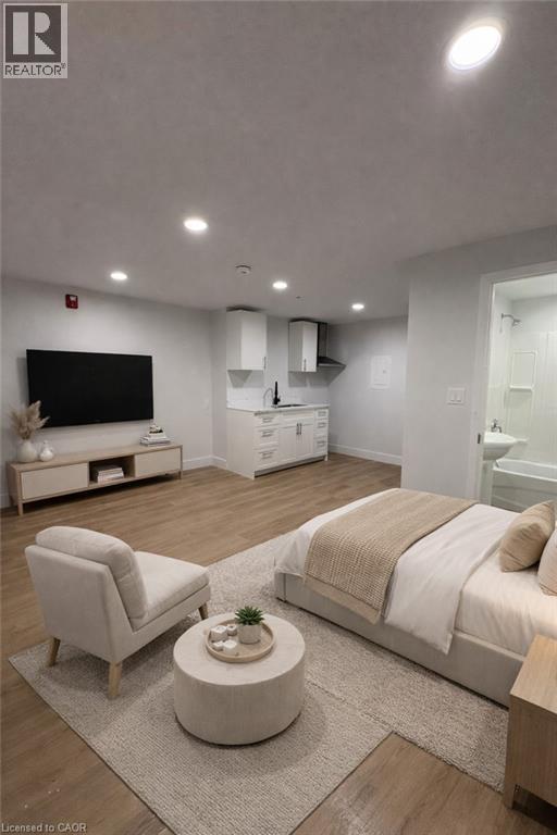 A modern bedroom with a large bed and a flat screen TV.