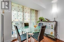 A dining room with a glass table and chairs.