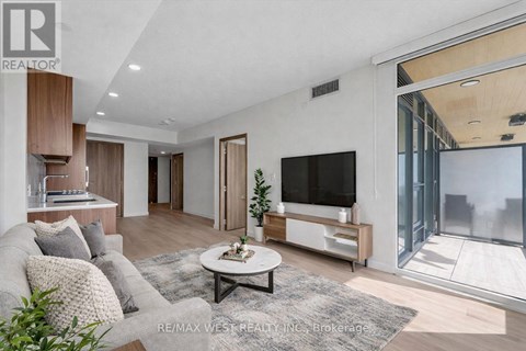 A modern living room with a grey sofa and a white coffee table.