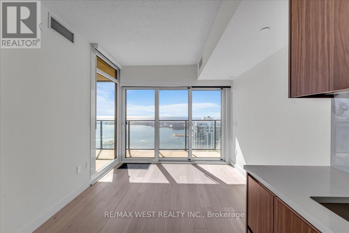 A spacious room with a view of the city through large windows.
