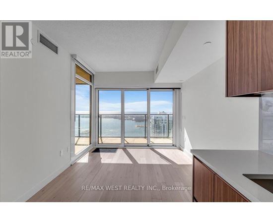 A spacious room with a view of the city through large windows.