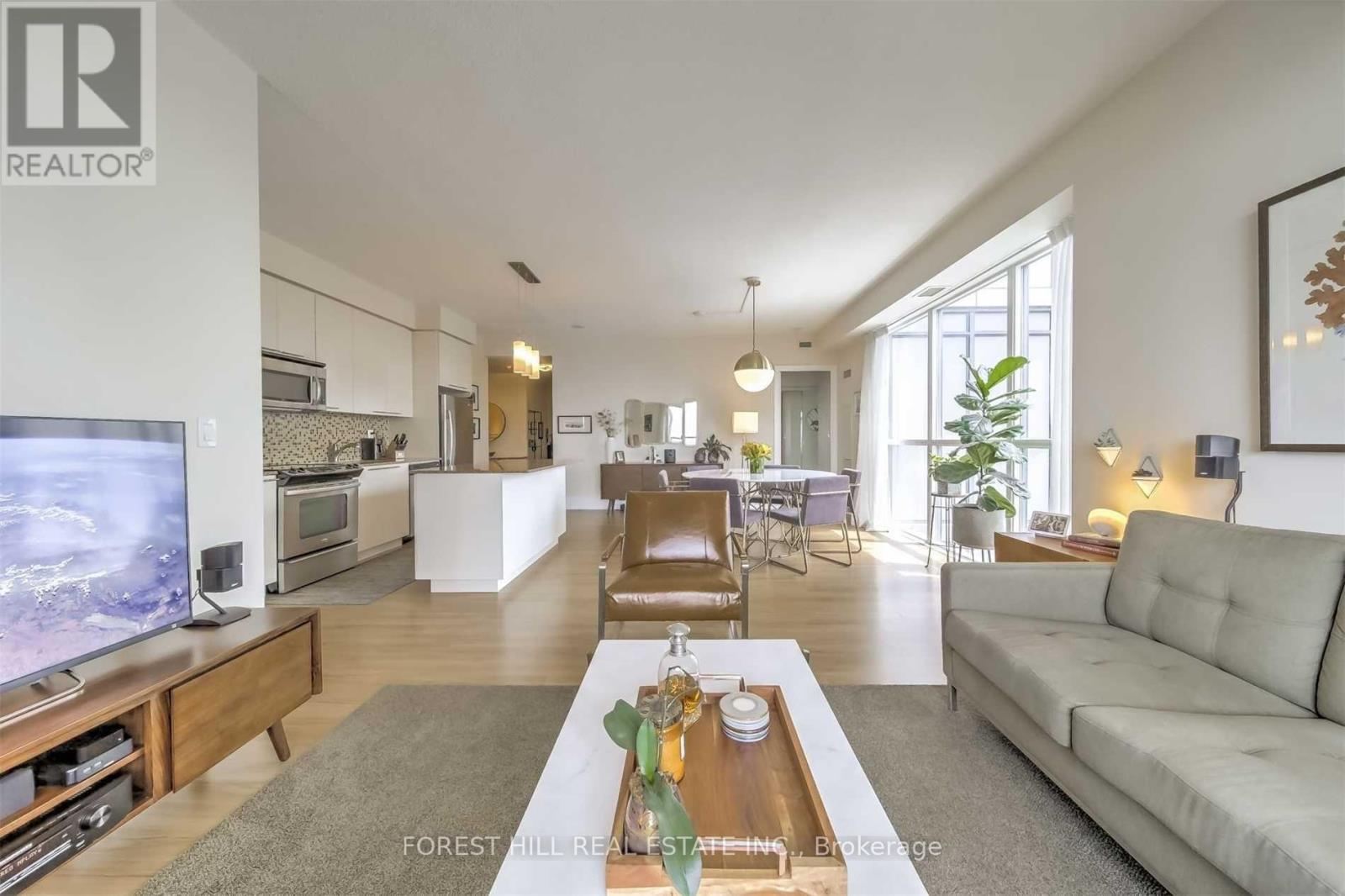 A living room with a grey couch and a wooden coffee table.