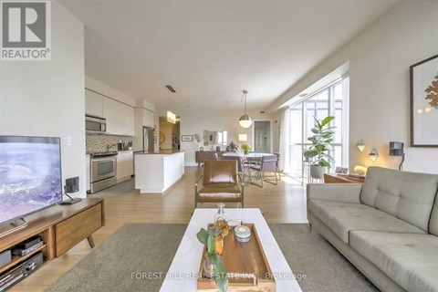A living room with a grey couch and a wooden coffee table.