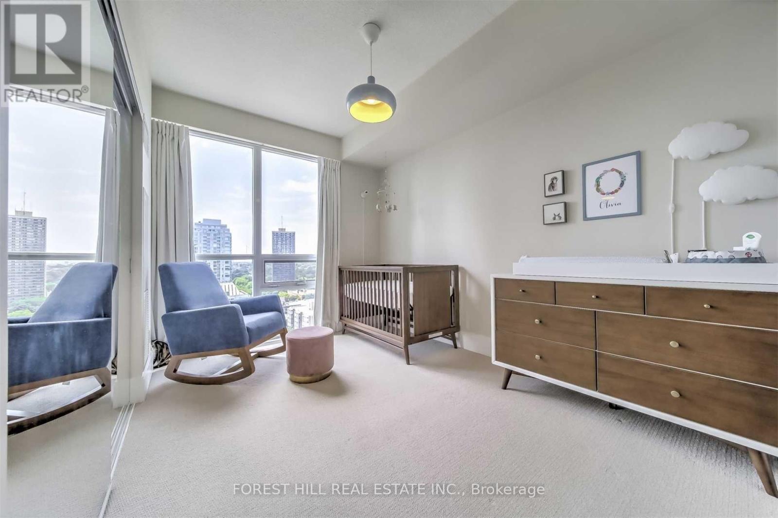 A well-lit, spacious room with a view of the city skyline.