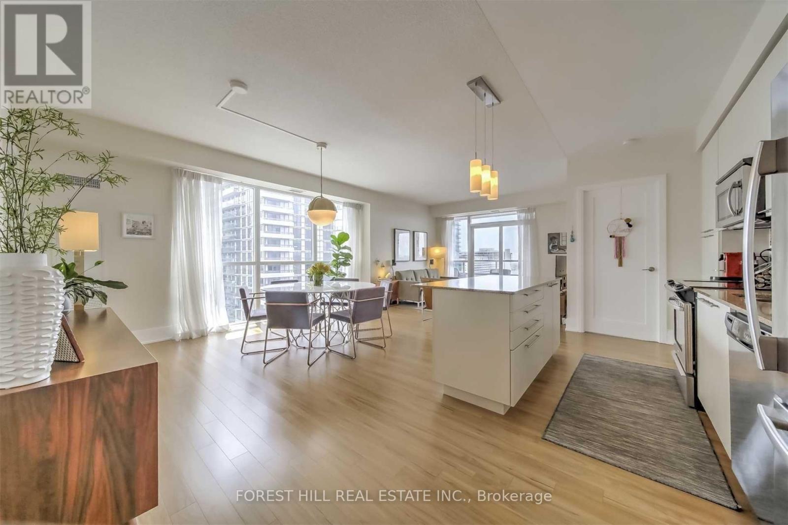 A modern kitchen with a dining table and chairs.