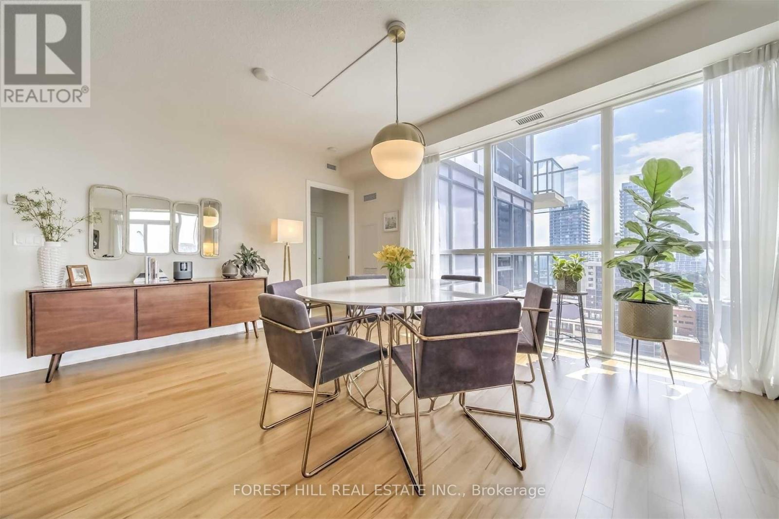 A dining room with a table set for four.