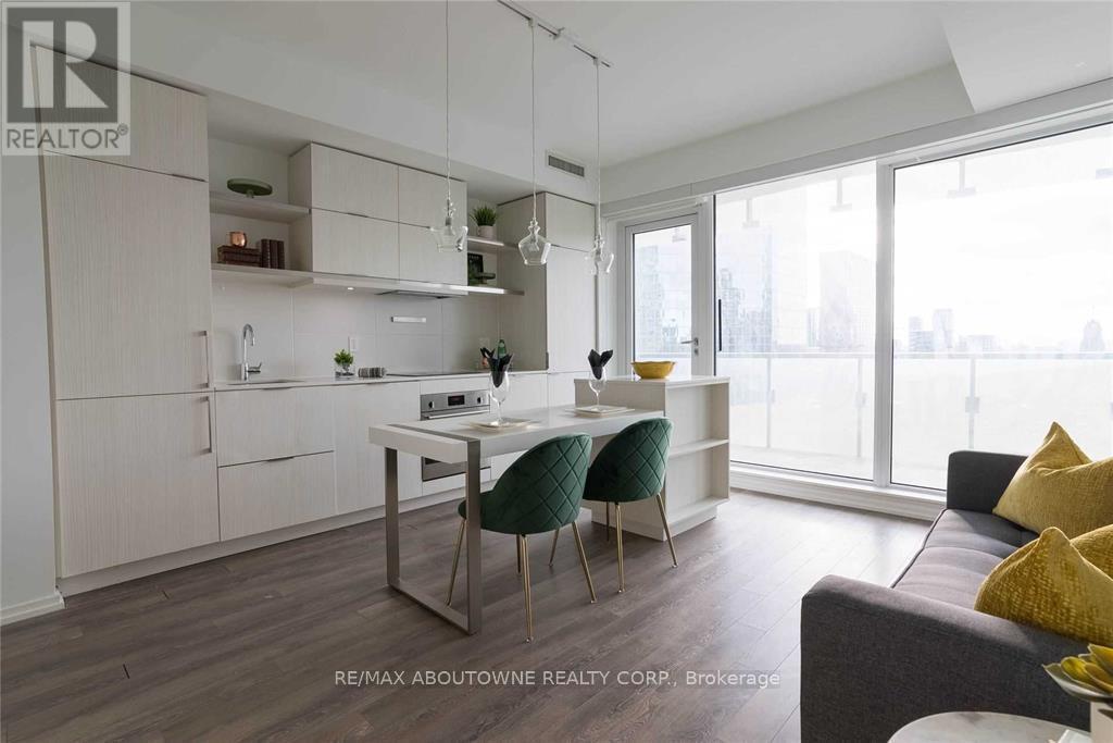 A modern kitchen with white cabinets and a dining table with chairs.