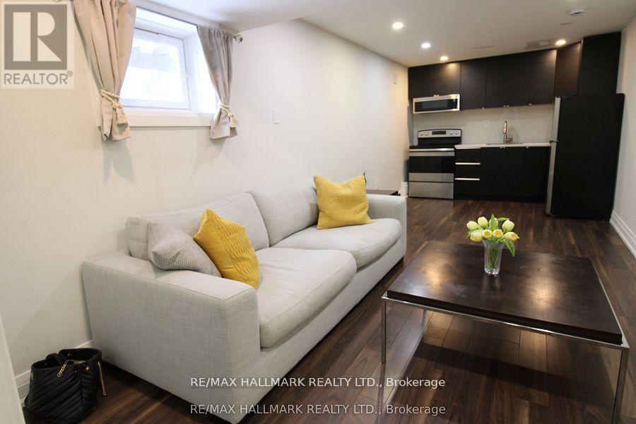 A modern living room with a grey sofa and a coffee table.
