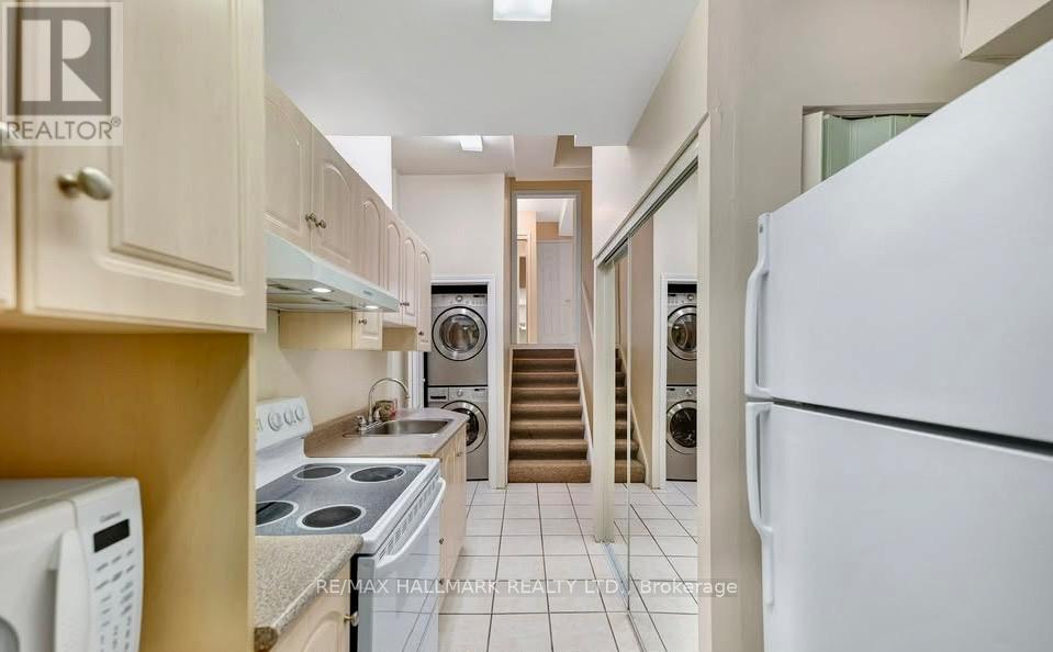 A kitchen with a white refrigerator, stove, and oven.