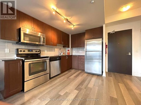 A kitchen with wooden cabinets and stainless steel appliances.