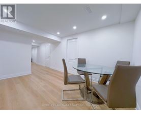 A dining room with a glass table and chairs.
