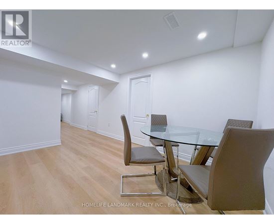 A dining room with a glass table and chairs.
